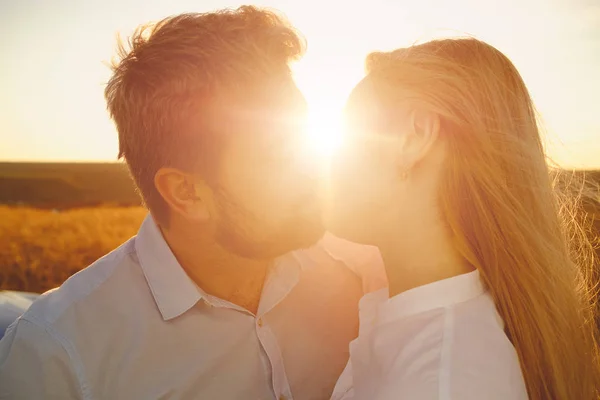 Couple kissing on the background of a sunset — Stock Photo, Image