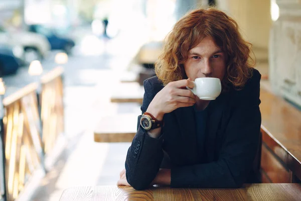 Portrait fashionable man drinking coffee