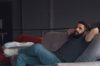 Young man sitting relaxing on the couch