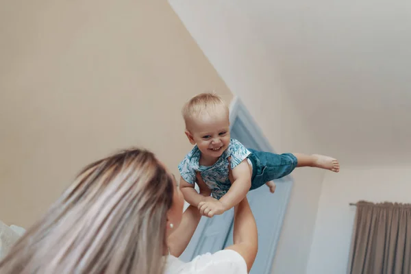 Jeune mère s'amuser à rire en jouant à des jeux actifs drôles avec enfant mignon fils dans la chambre — Photo