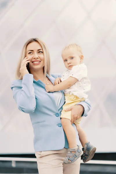 Egy sikeres üzletasszony portréja kék öltönyben babával — Stock Fotó