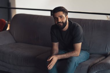 Young man sitting relaxing on the couch