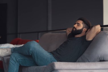 Young man sitting relaxing on the couch