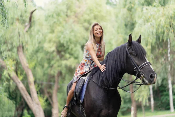 Young Woman Bright Colorful Dress Riding Black Horse Park — Stock Photo, Image