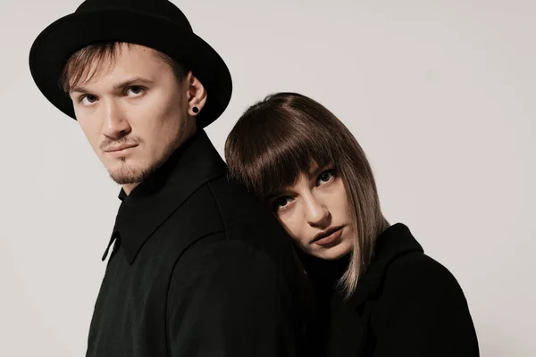 Millennial fashion couple on a white gray background in studio — Stock Photo, Image