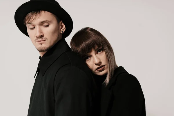 Millennial fashion couple on a white gray background in studio — Stock Photo, Image