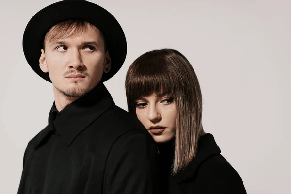 Millennial fashion couple on a white background in studio