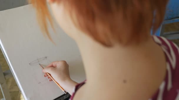 En ung konstnär i en konstverkstaden ritar ett stilleben av en skiss från naturen i blyerts. — Stockvideo