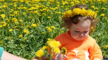 Bir bahar glade içinde dandelions ailesiyle birlikte mutlu çocuk.