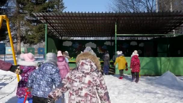 Arkadan Görünüm dışında kışın karda yürüme çocuklar — Stok video
