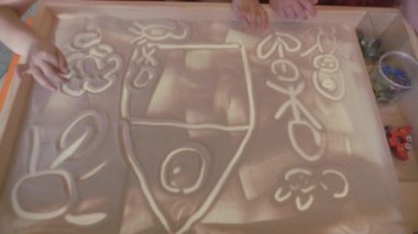 Childrens sand therapy. Childrens games with sand. Educational activities in the game room.