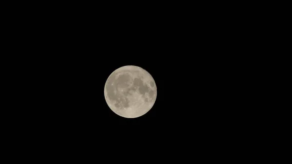 Full moon against the black night sky. Craters and mountains surface of the earth\'s satellite.