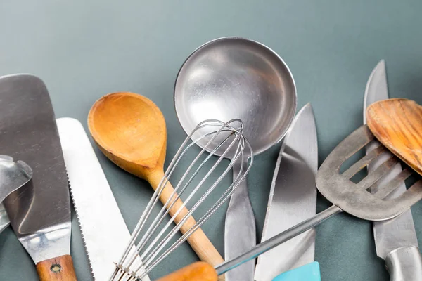 Used home kitchenware with scratches on gray paper background — Stock Photo, Image