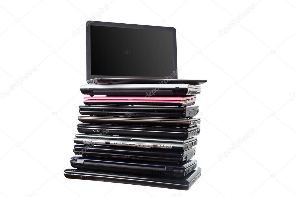 Stack of used laptops in different colors and models. Tha notebooks for repair and service.