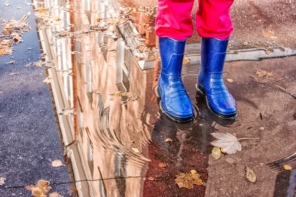 Pernas de menina de pé em uma piscina de outono — Fotografia de Stock
