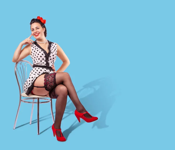 Young pretty smiling woman sitting on a chair. pinup style — 스톡 사진