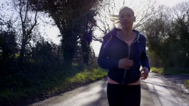 Woman running in the countryside — Stock Video