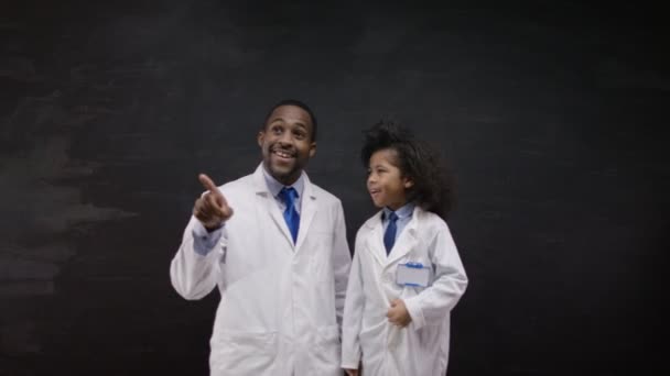 Man and boy in white coats — Stock video