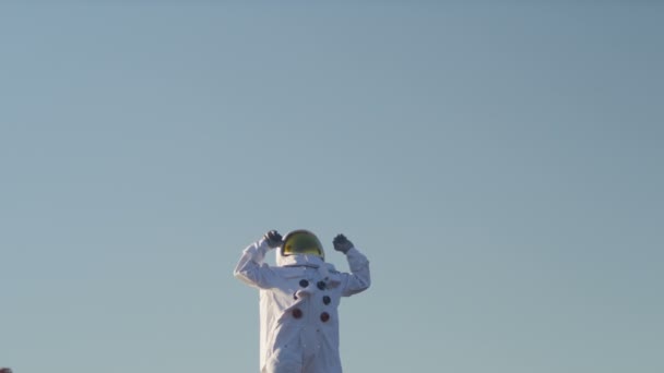 Astronaut stretches out his arms — Stock Video