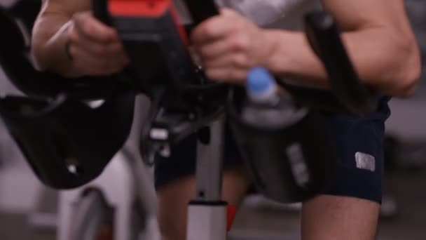 Hombre haciendo ejercicio en bicicleta estática — Vídeos de Stock