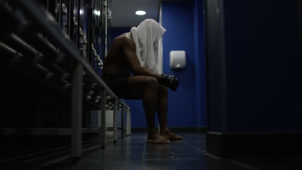 MMA fighter sits alone in locker room — Stock Video