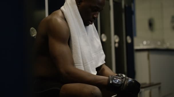 MMA fighter sits alone in locker room — Stock Video