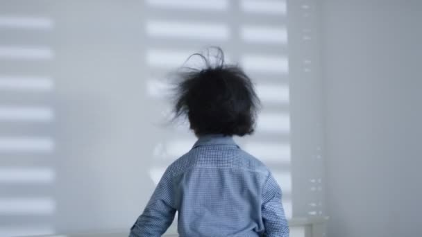 Boy jumping up and down on the bed — Stock Video