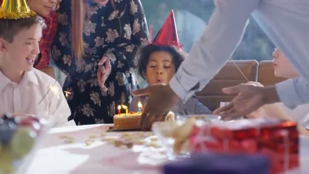 Boy blows out candles on cake — Stock Video