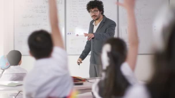 Escolares en clase escuchando a la maestra — Vídeos de Stock