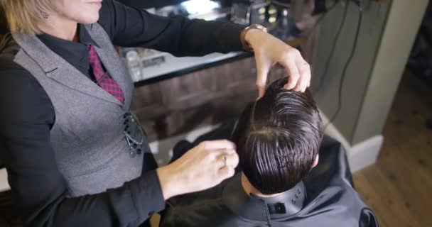 Estilista se preparando para cortar o cabelo do cliente — Vídeo de Stock