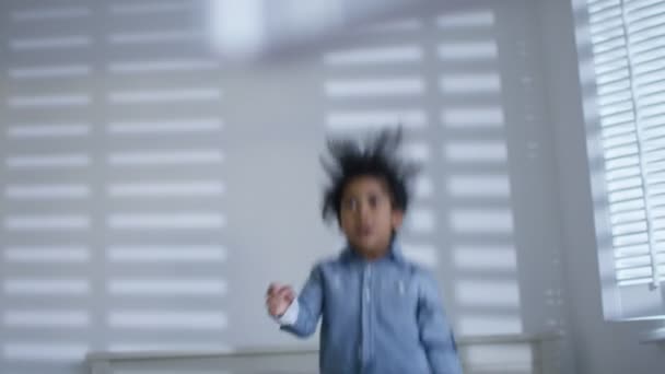 Boy jumping up and down on the bed — Stock Video