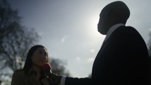 Woman giving live interview to reporter — Stockvideo