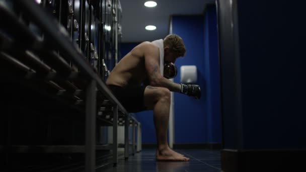 MMA fighter sits in locker room — Stock video