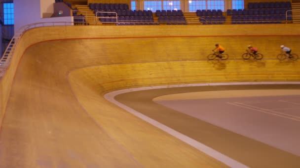 Competitive cyclists racing on track — Stock Video