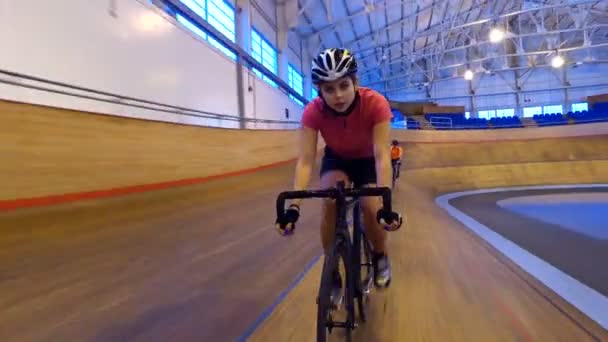 Competitive cyclists racing on track — Stock Video