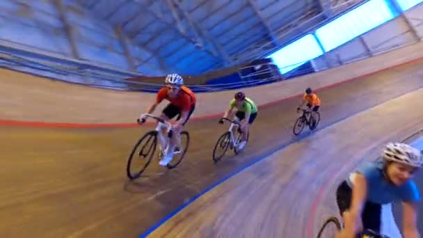 Competitive cyclists racing on track — Stock Video