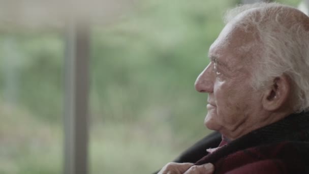 Uomo anziano seduto vicino alla finestra — Video Stock