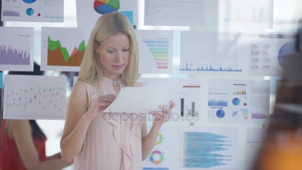 Businesswoman Looking Papers Front Screen Charts Graphs — Stock Video