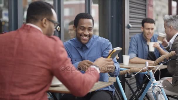 Men Chatting Outdoor City Cafe Table Looking Computer Tablet — Stock Video