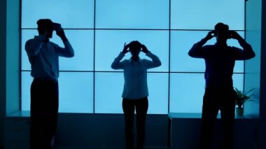 4 k iş takım içinde trying dışarı sanal reality izleyiciler mavi zemin üzerine siluet