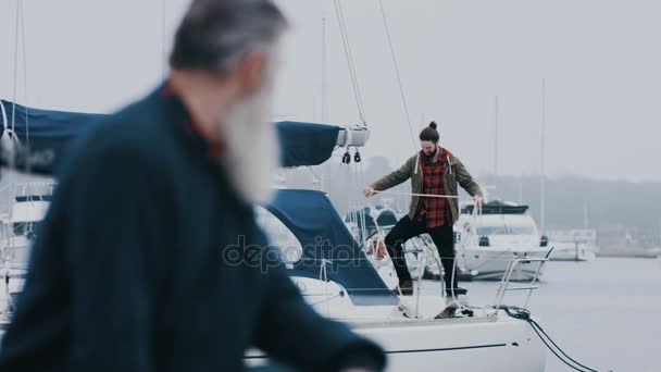 Portrait Mature Man Yacht Docked Marina Talking Young Man Background — Stock Video