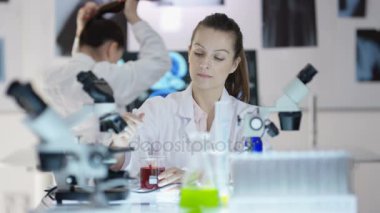 Bilimsel araştırma ekibi kimyasallar ile deneme kadın odaklanmak laboratuarında çalışıyor