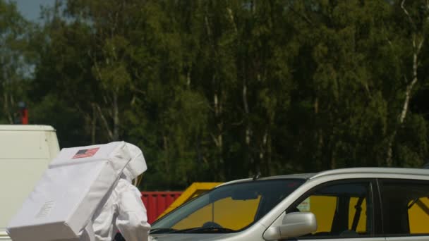 Hooligan Astronaut Climbing Roof Car Holding Baseball Bat — Stock Video