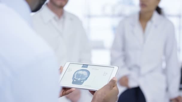 Medical Team Meeting Man Holding Tablet Showing Skull Ray — Stock Video