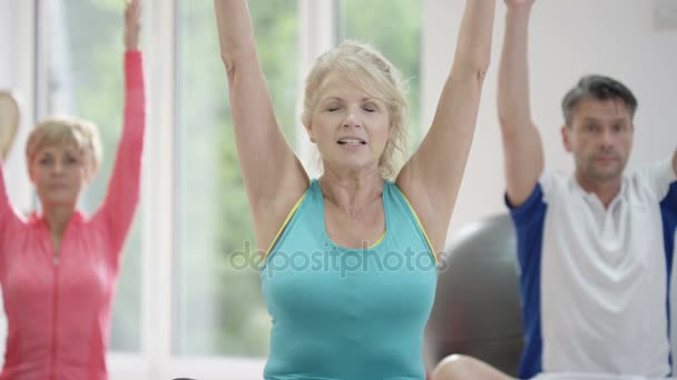 Mature Female Fitness Instructor Working Out Clients Exercise Class — Stock Video