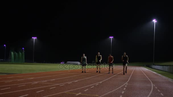 Competitive Male Athletes Running Race Track Dark — Stock Video