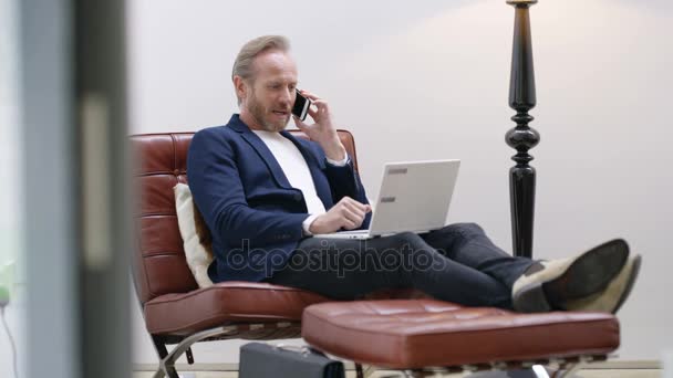 Atraente Homem Inteligentemente Vestido Casa Falando Telefone Trabalhando Laptop — Vídeo de Stock