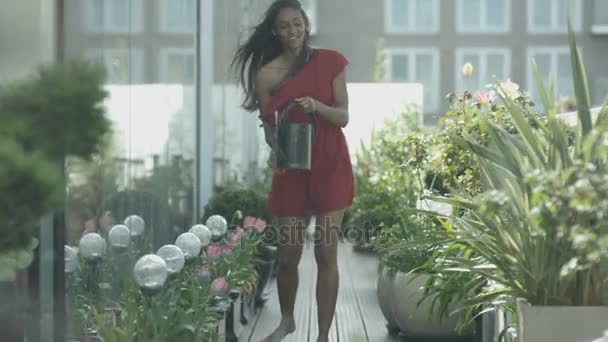 Woman Watering Plants Looking Out View City Rooftop Garden — Stock Video