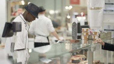 bir gülümseme ile müşterilerine hizmet süpermarket Şarküteri karşı 4k mutlu işçi