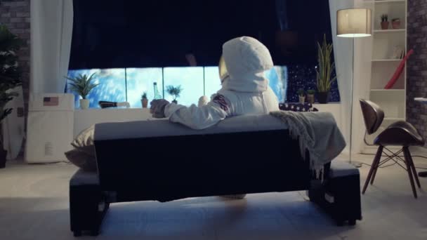 Astronaut Relaxing Apartment Looking View Planet Earth — Stock Video